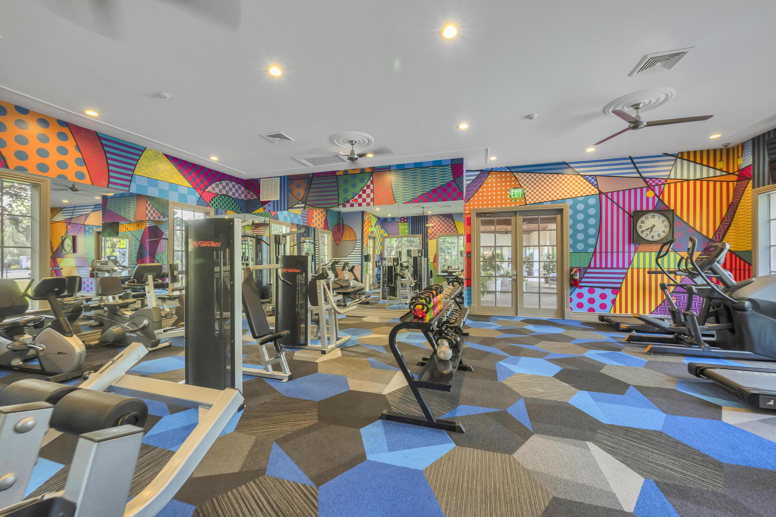 367 Southeast Rogers Court Stuart, FL 34994 - Photo 32 of 35 a room with lots of gym equipment and large windows
