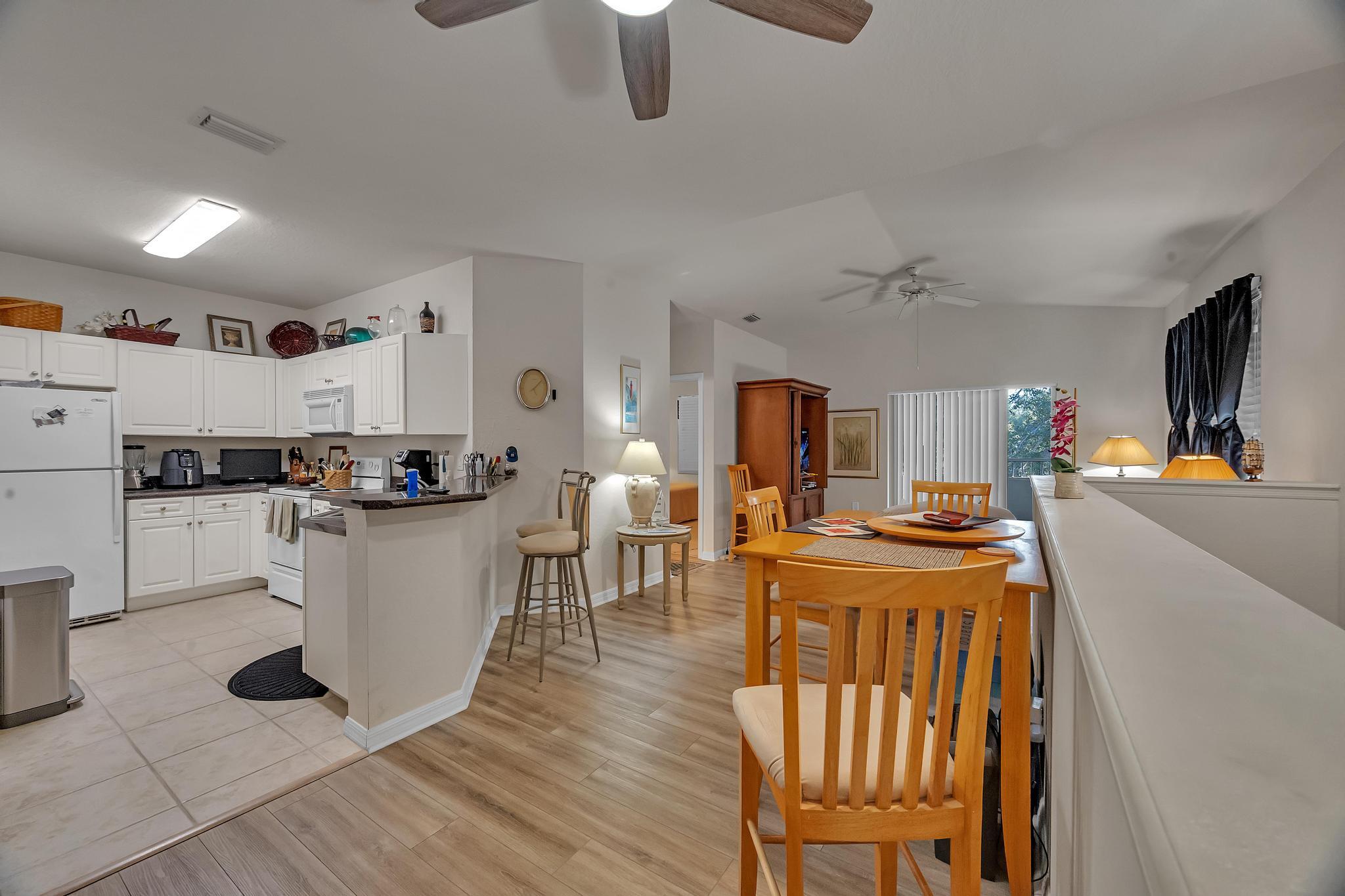 367 Southeast Rogers Court Stuart, FL 34994 - Photo 5 of 35 a kitchen with a table and chairs