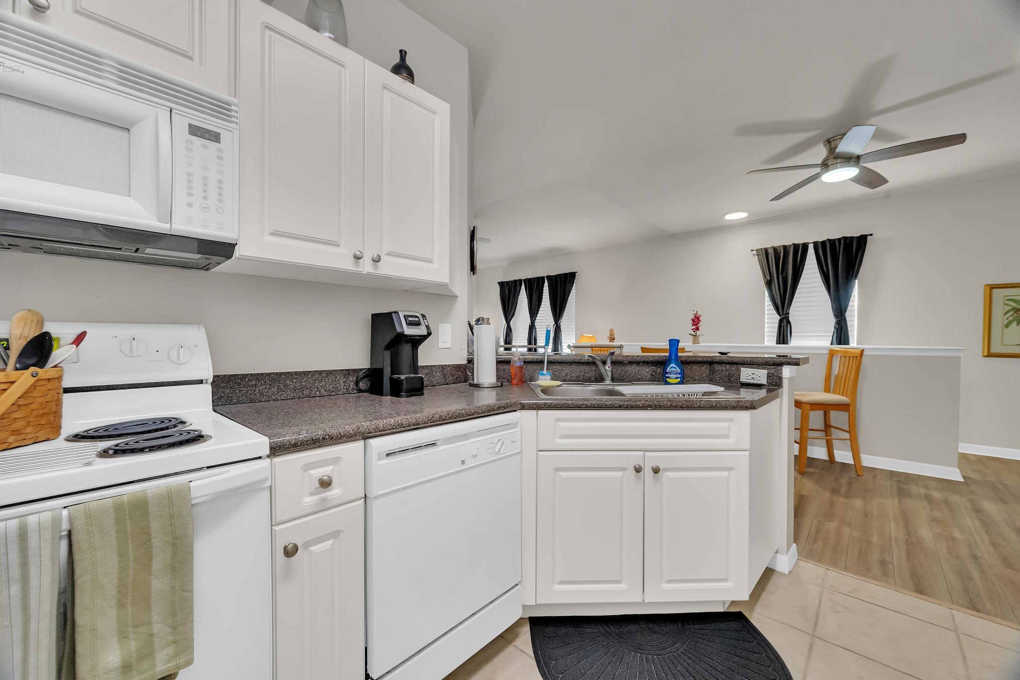 367 Southeast Rogers Court Stuart, FL 34994 - Photo 10 of 35 a kitchen with white cabinets and appliances