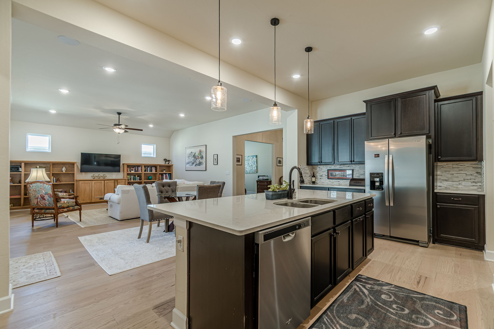 136 Calming Agave Way San Marcos, TX 78666 - Photo 18 of 40 a large kitchen with kitchen island a sink table and chairs