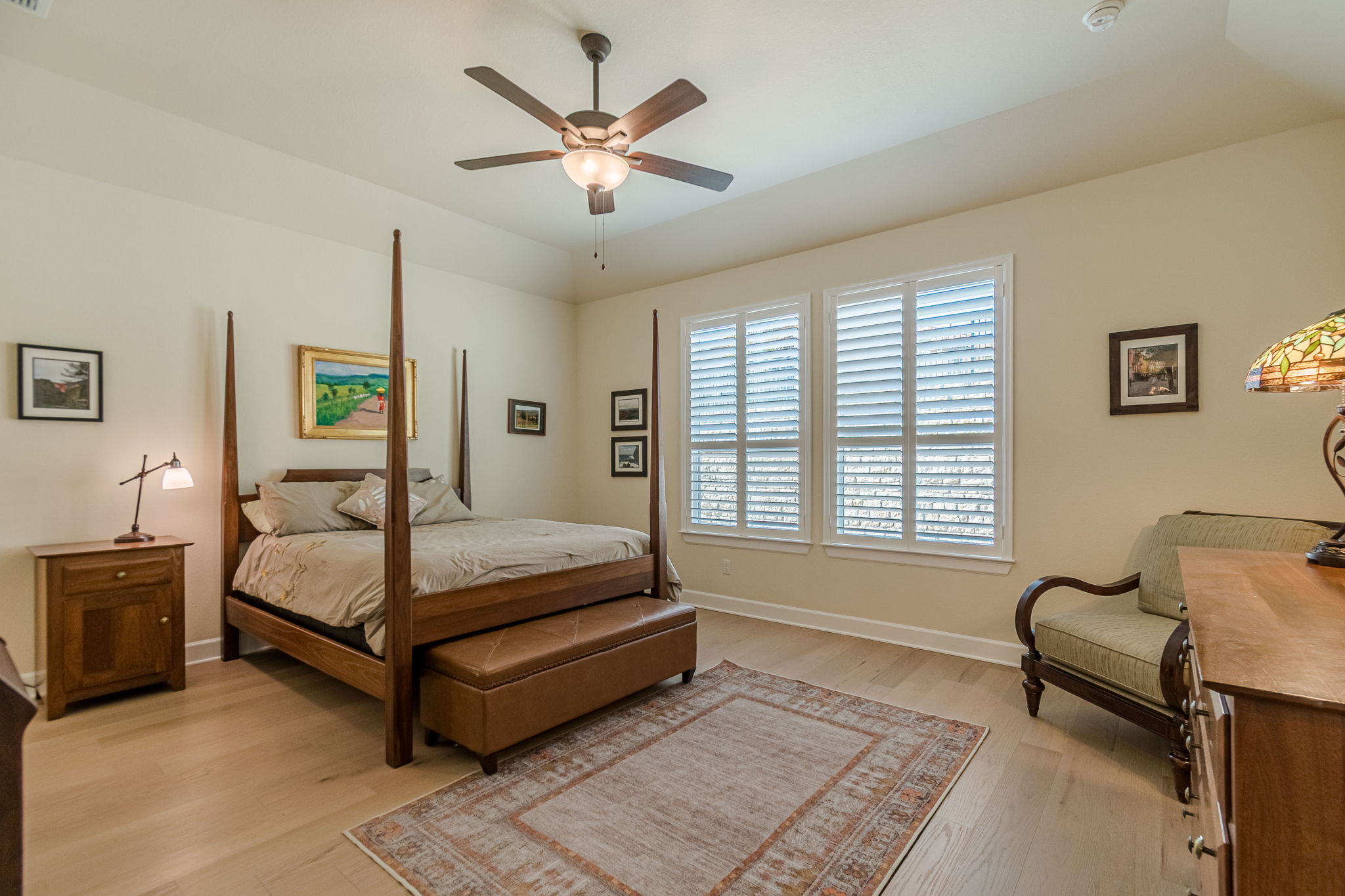 136 Calming Agave Way San Marcos, TX 78666 - Photo 26 of 40 a bedroom with a bed and a chandelier