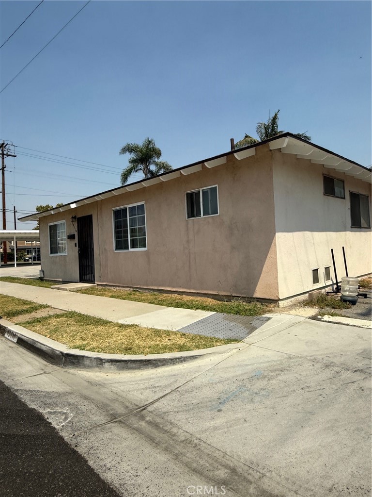 13108 Brock Avenue Paramount, CA 90723 - Photo 11 of 16 a view of a house with a yard and garage