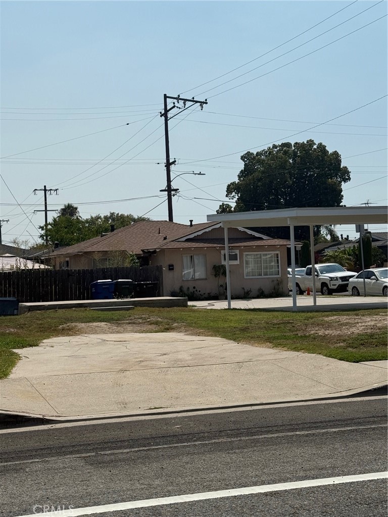 13108 Brock Avenue Paramount, CA 90723 - Photo 2 of 16 a view of a swimming pool with a lawn chairs under an umbrella