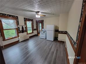 393 Highland Avenue, Unit 2 Waterbury, CT 06708 - Photo 8 of 10 a view of a kitchen with fridge and wooden floor