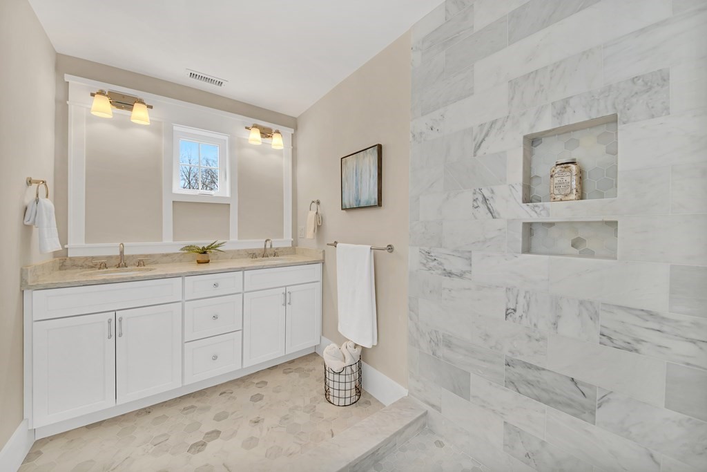 401 Albemarle Road, Unit 1 Newton, MA 02460 - Photo 19 of 42 a bathroom with double sink and a mirror