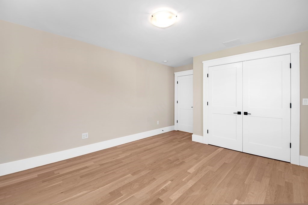 401 Albemarle Road, Unit 1 Newton, MA 02460 - Photo 23 of 42 a view of an empty room with wooden floor