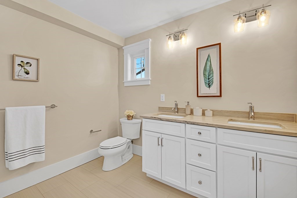 401 Albemarle Road, Unit 1 Newton, MA 02460 - Photo 28 of 42 a bathroom with a toilet sink and mirror