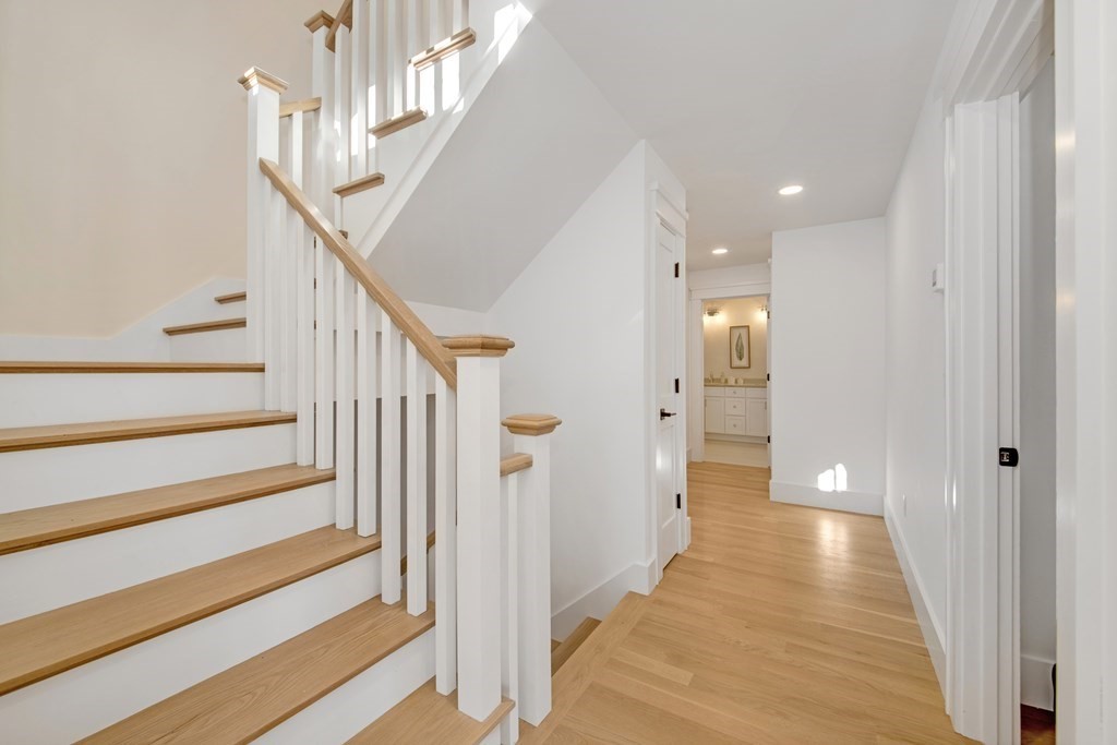 401 Albemarle Road, Unit 1 Newton, MA 02460 - Photo 29 of 42 a view of a hallway with a hallway and stairs with wooden floor