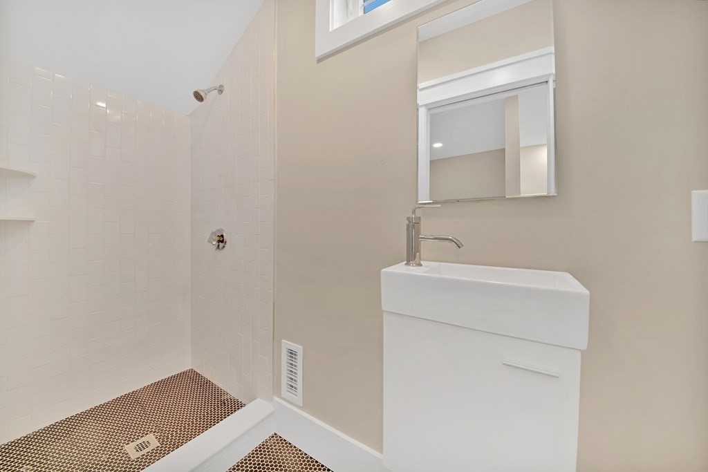 401 Albemarle Road, Unit 1 Newton, MA 02460 - Photo 32 of 42 a bathroom with a sink and a vanity