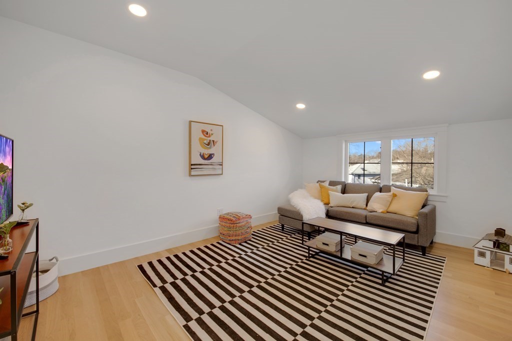 401 Albemarle Road, Unit 1 Newton, MA 02460 - Photo 33 of 42 a living room with furniture and a wooden floor