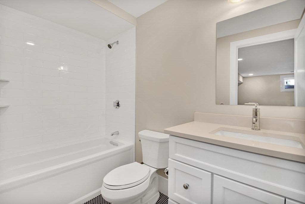 401 Albemarle Road, Unit 1 Newton, MA 02460 - Photo 40 of 42 a bathroom with a sink a toilet and shower