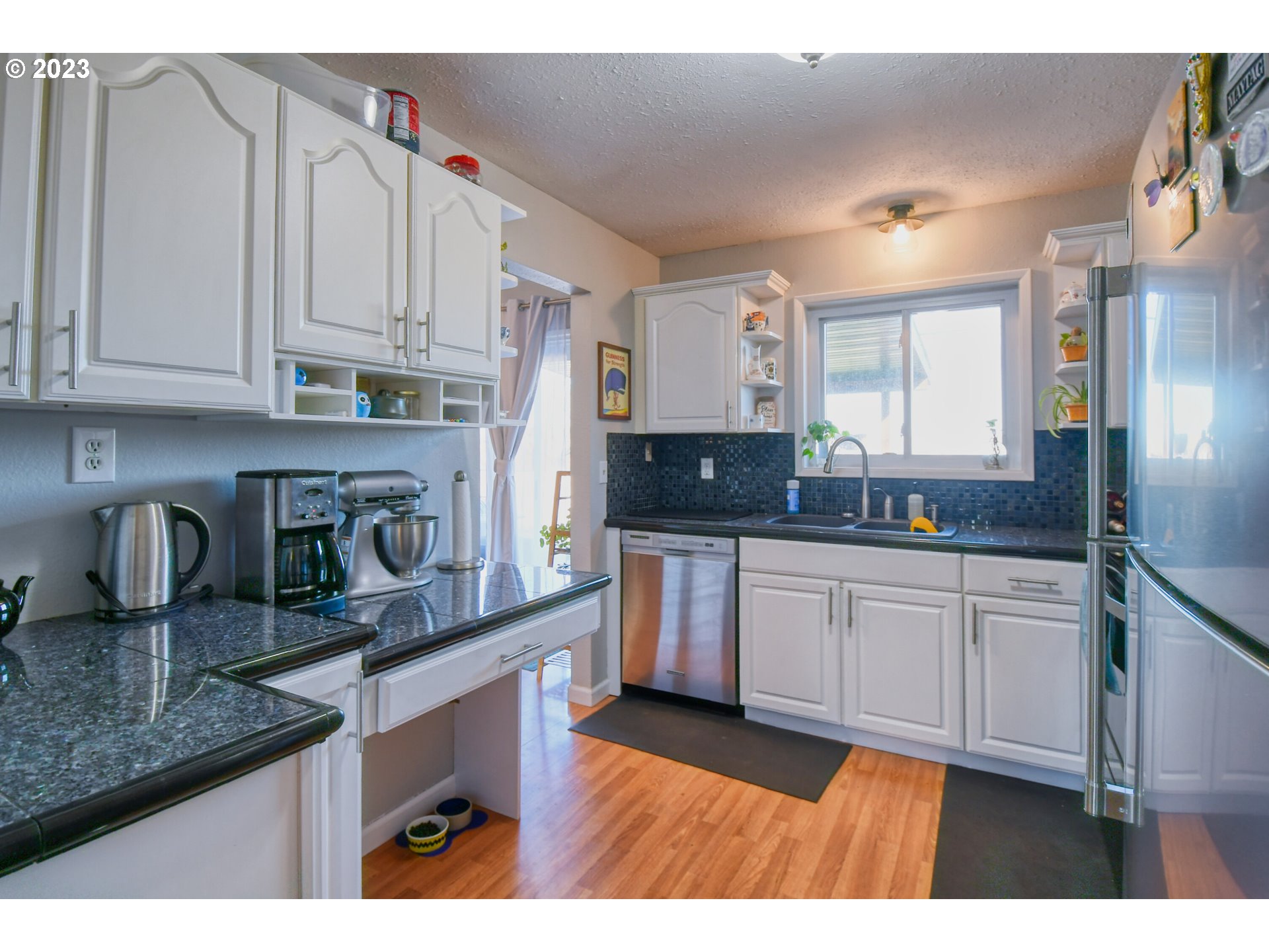 2437 Southwest Ladow Avenue Pendleton, OR 97801 - Photo 11 of 32 a kitchen with granite countertop a sink a stove and cabinets
