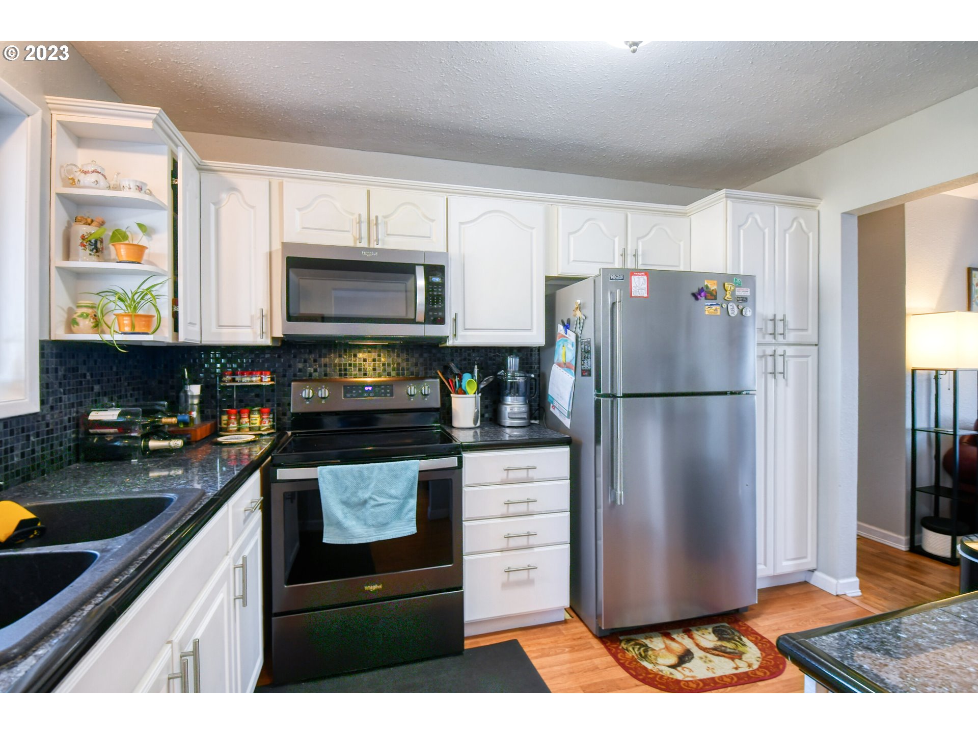 2437 Southwest Ladow Avenue Pendleton, OR 97801 - Photo 12 of 32 a kitchen with a refrigerator and a stove