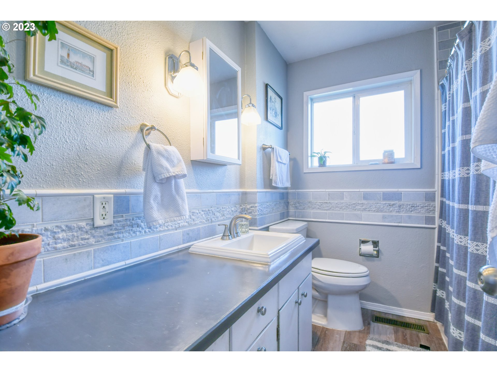 2437 Southwest Ladow Avenue Pendleton, OR 97801 - Photo 16 of 32 a bathroom with a sink a toilet and a mirror