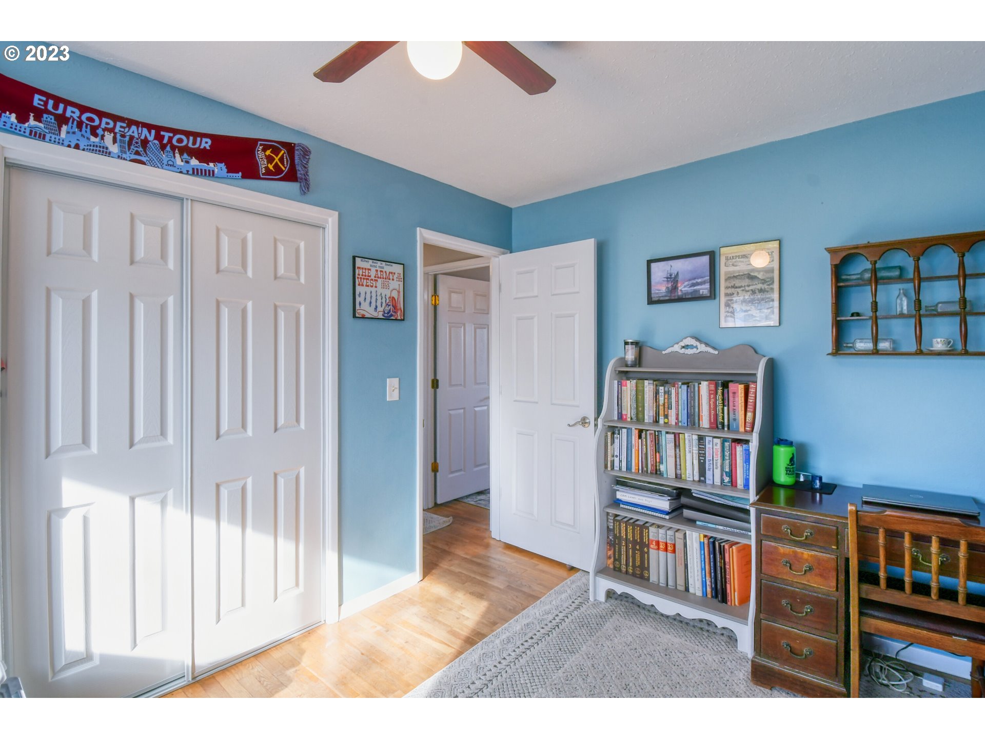 2437 Southwest Ladow Avenue Pendleton, OR 97801 - Photo 22 of 32 a living room with furniture and a book shelf