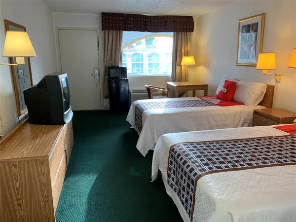 a bedroom with a bed and a lamp