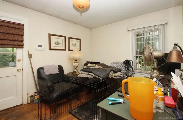a living room with furniture stove and wooden floor