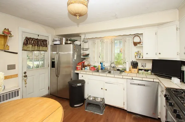 a kitchen with a sink appliances and cabinets