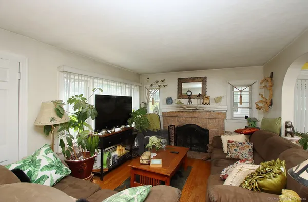 a living room with furniture a fireplace and a flat screen tv