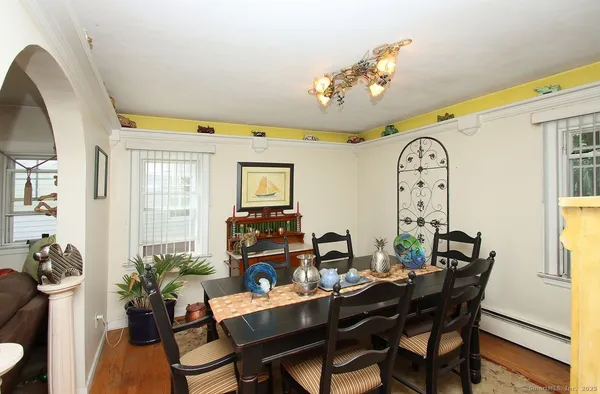 a view of a dining room with furniture and a large window