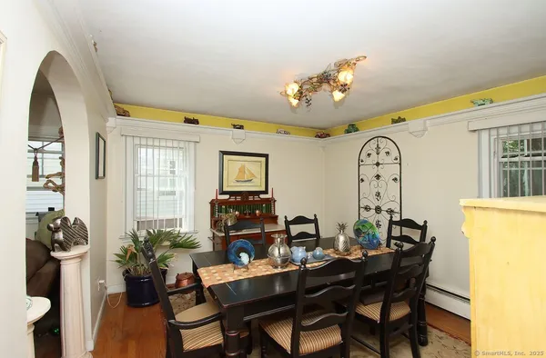 a view of a dining room with furniture and a large window