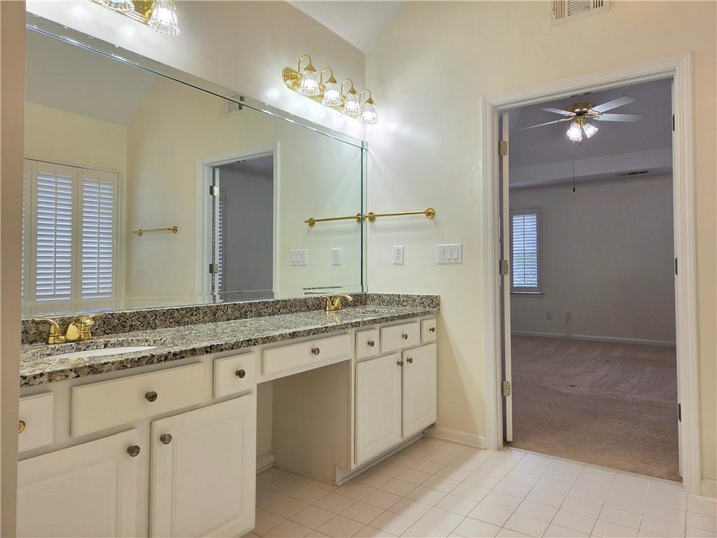 3715 Ridgeside Court Suwanee, GA 30024 - Photo 29 of 44 a bathroom with a granite countertop sink and a mirror