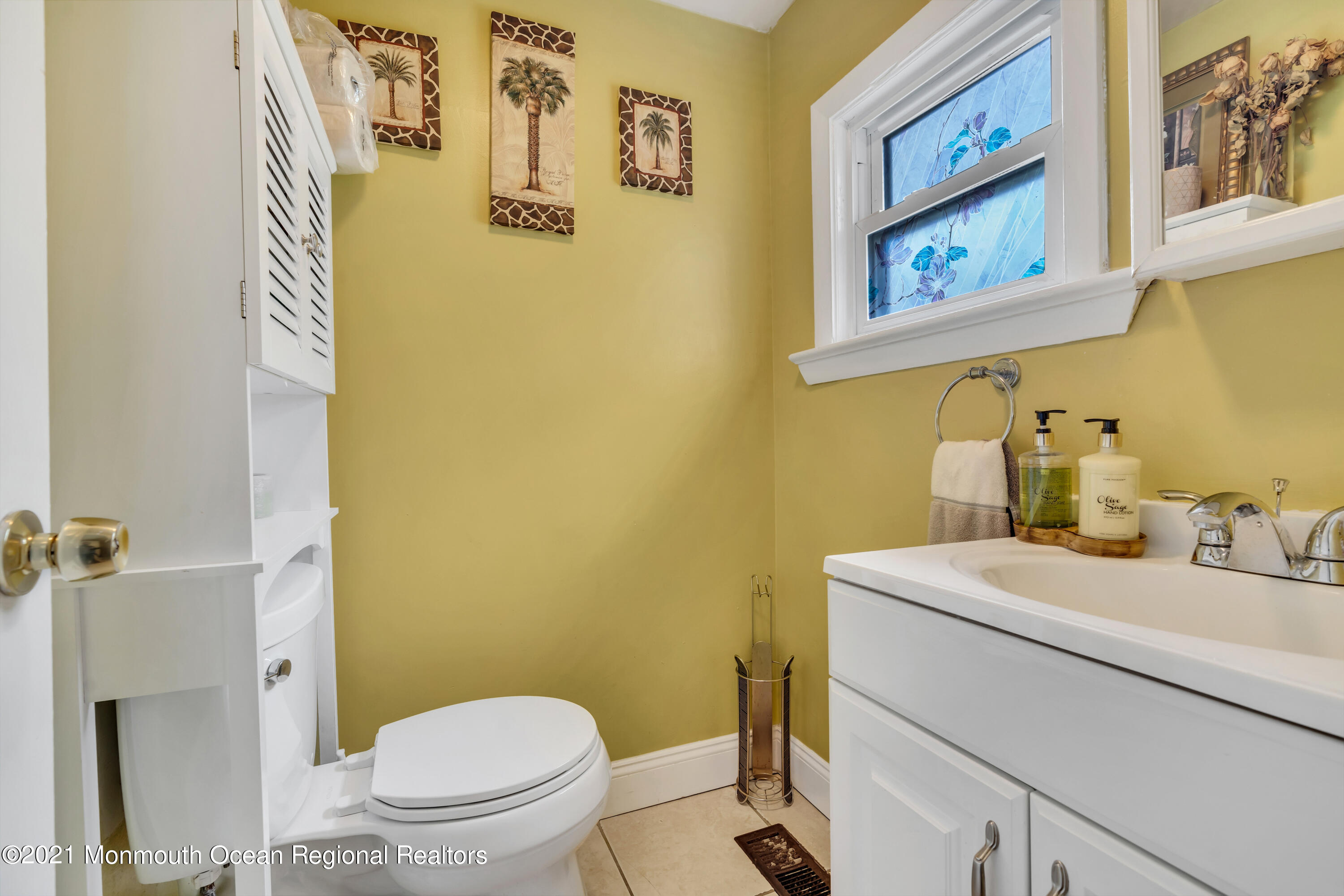 1209 7th Avenue, Unit 1/2 Neptune Township, NJ 07753 - Photo 14 of 19 a bathroom with a toilet sink and mirror