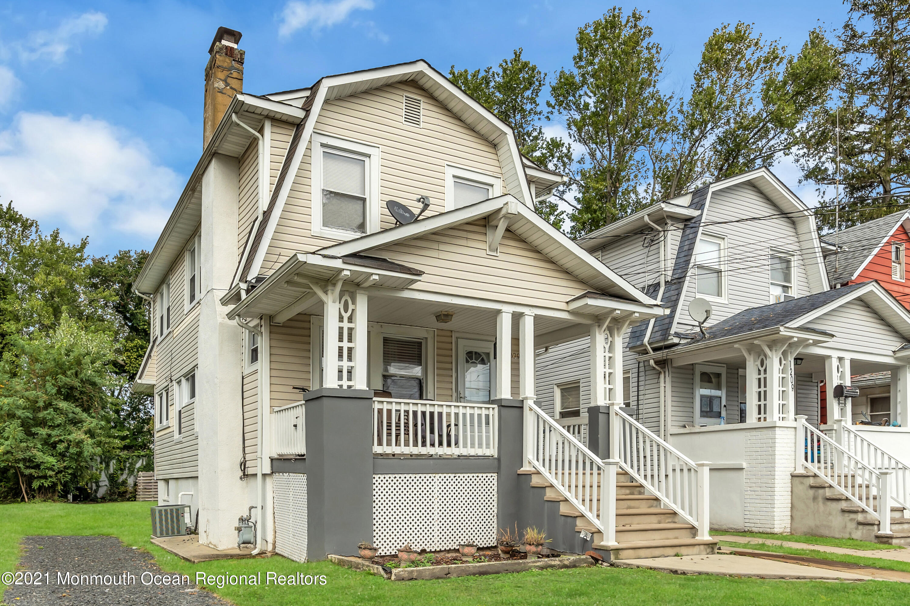 1209 7th Avenue, Unit 1/2 Neptune Township, NJ 07753 - Photo 2 of 19 a view of a white house with large windows and a yard