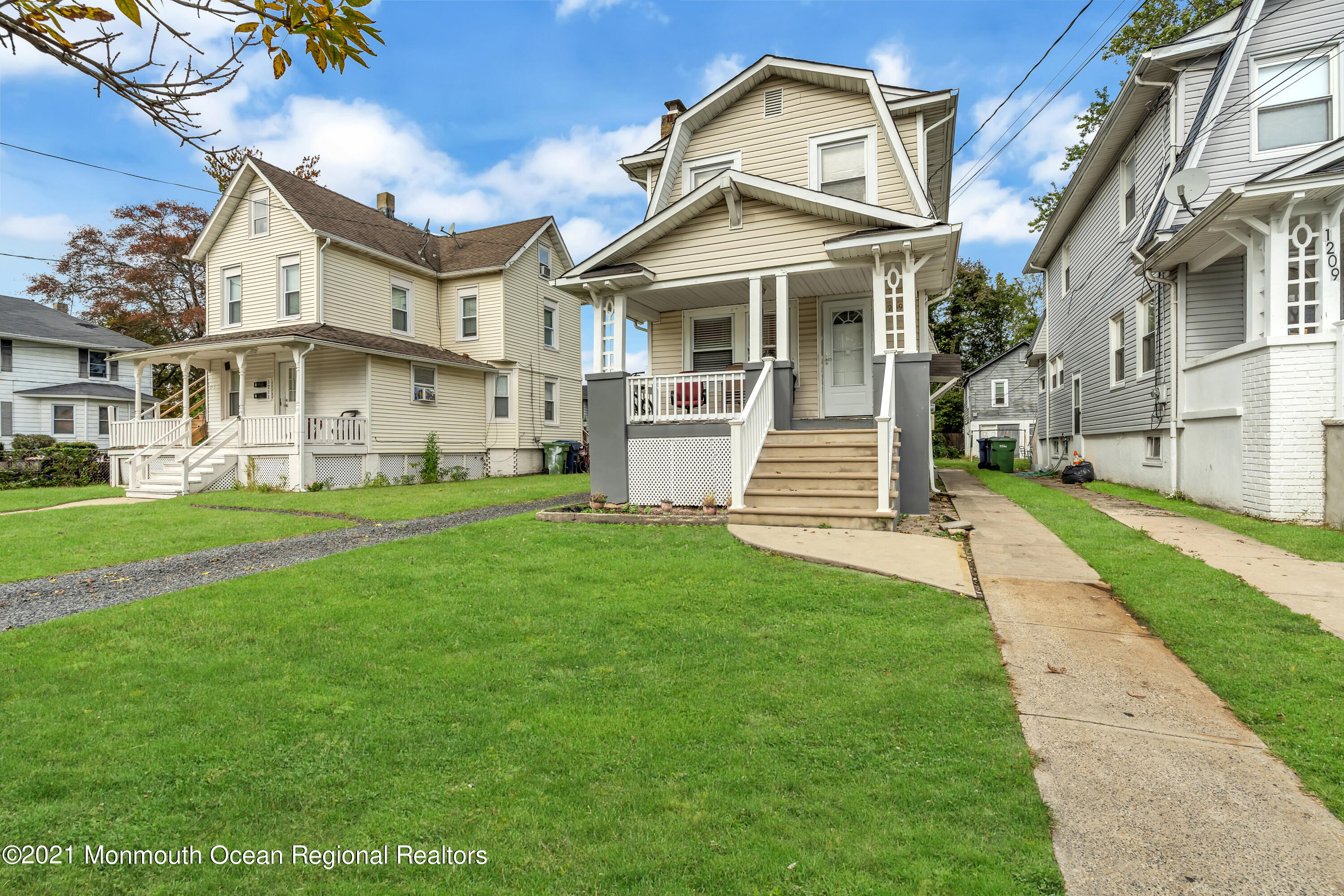 1209 7th Avenue, Unit 1/2 Neptune Township, NJ 07753 - Photo 3 of 19 a front view of a house with a yard