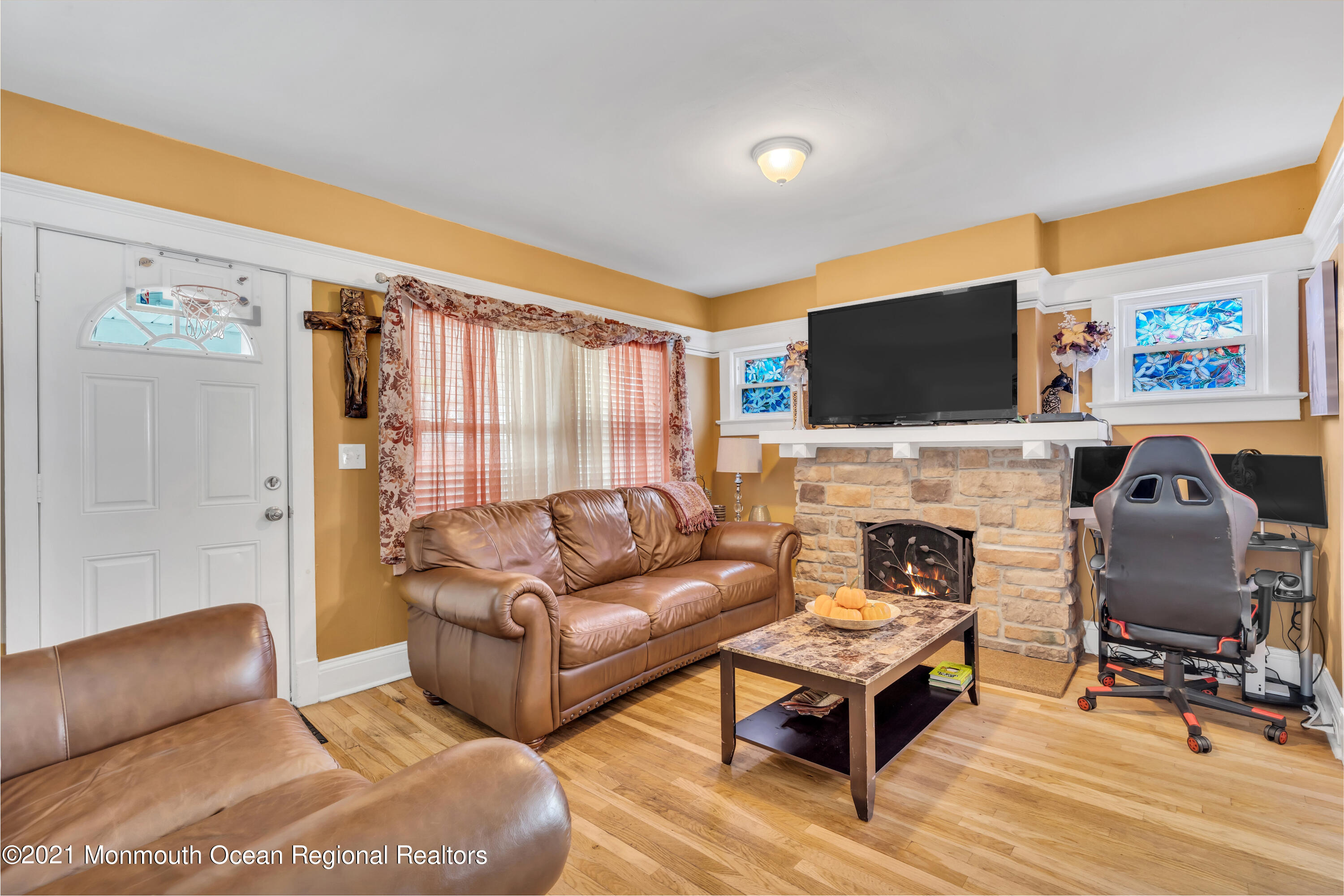 1209 7th Avenue, Unit 1/2 Neptune Township, NJ 07753 - Photo 5 of 19 a living room with furniture a fireplace and a flat screen tv