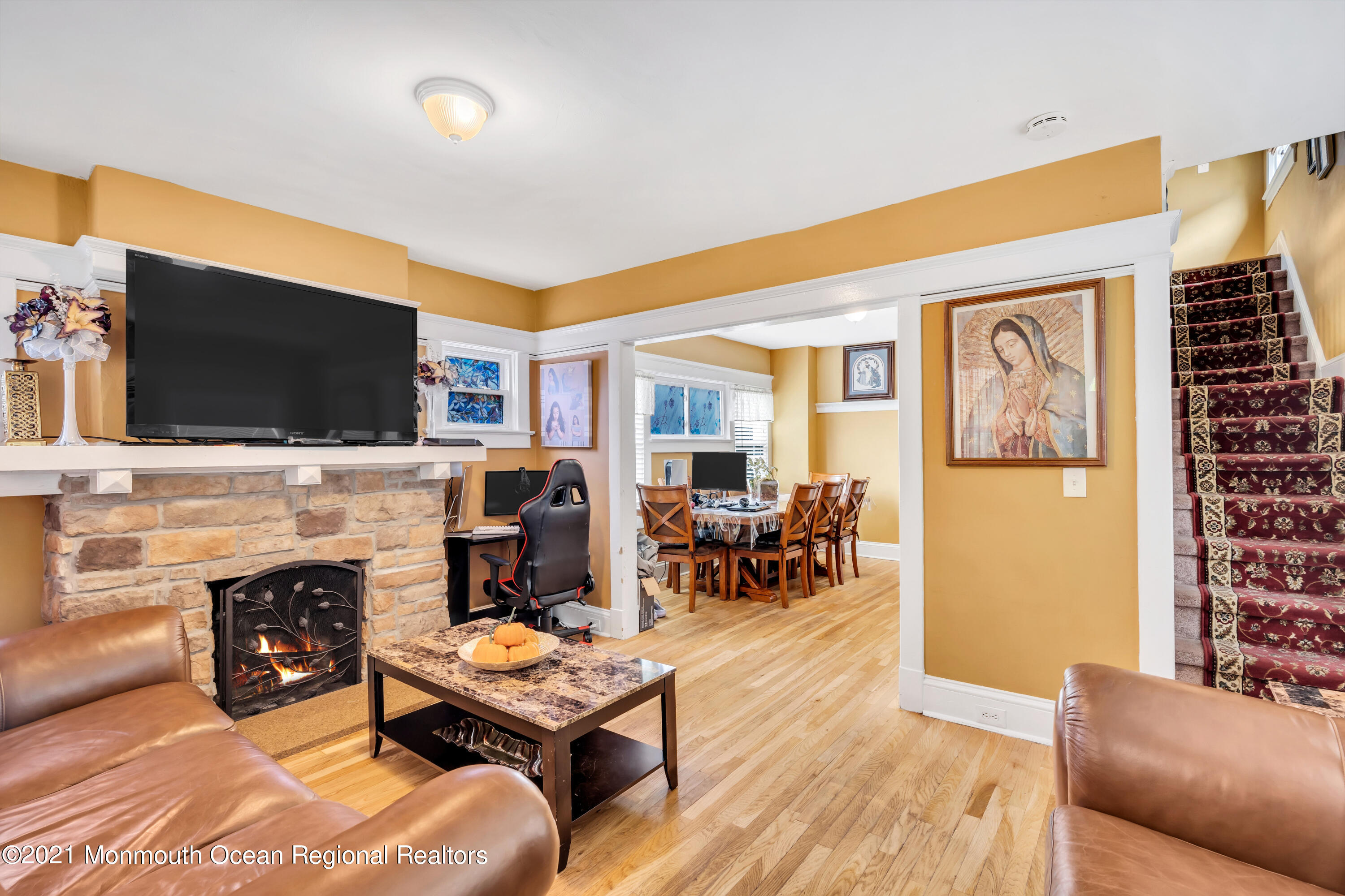 1209 7th Avenue, Unit 1/2 Neptune Township, NJ 07753 - Photo 7 of 19 a living room with furniture a flat screen tv and a fireplace