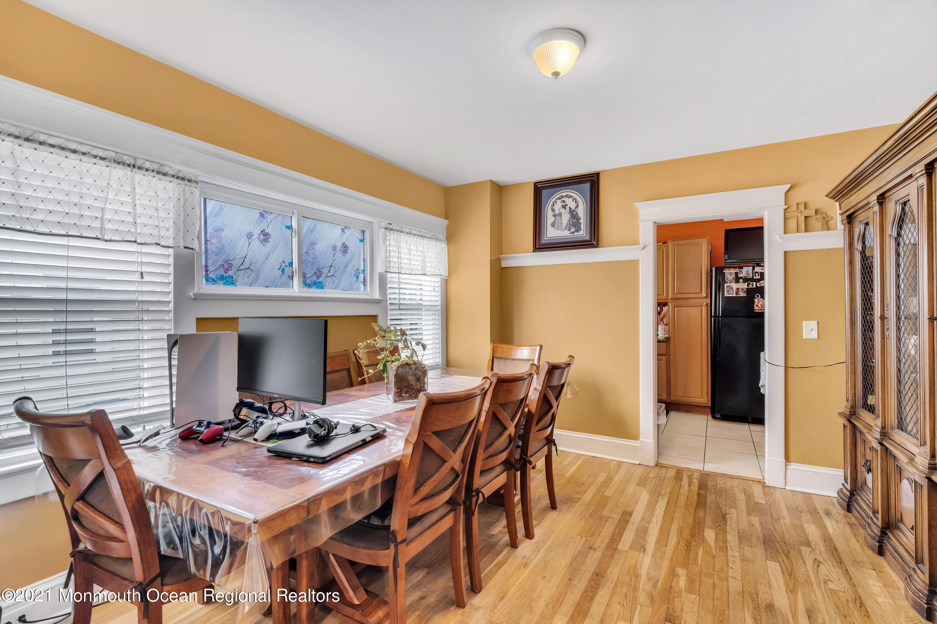 1209 7th Avenue, Unit 1/2 Neptune Township, NJ 07753 - Photo 8 of 19 a view of a dining room with furniture and wooden floor