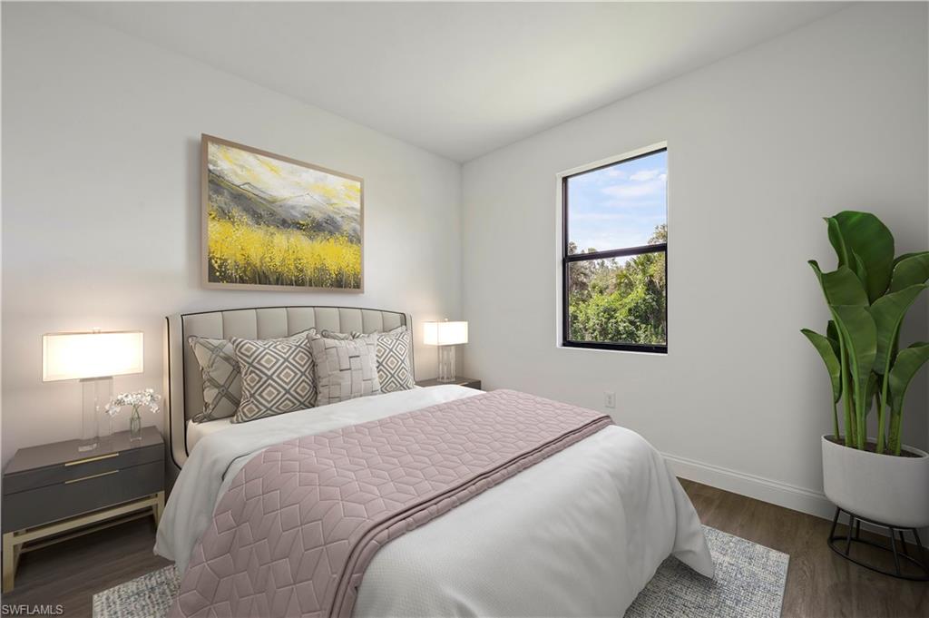 2617 3rd Street Southwest Lehigh Acres, FL 33976 - Photo 11 of 22 a bedroom with a bed and a potted plant