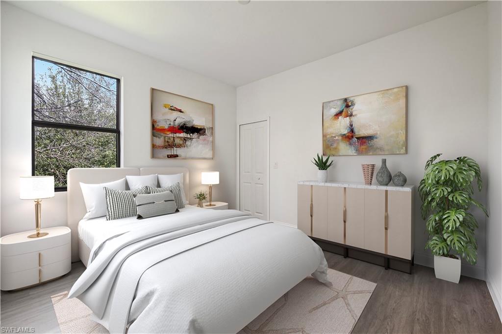 2617 3rd Street Southwest Lehigh Acres, FL 33976 - Photo 12 of 22 a bedroom with a bed and a furniture