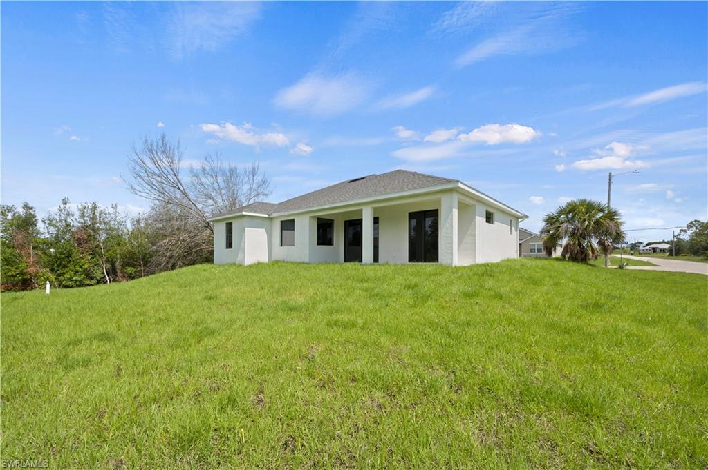 2617 3rd Street Southwest Lehigh Acres, FL 33976 - Photo 15 of 22 a front view of house with yard and green space