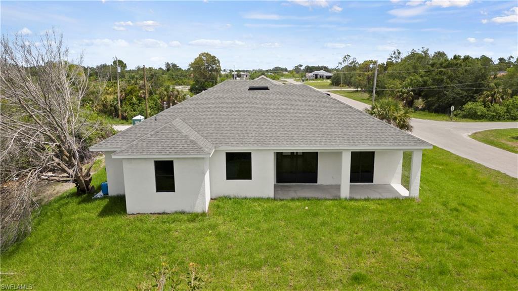 2617 3rd Street Southwest Lehigh Acres, FL 33976 - Photo 16 of 22 a front view of house with yard and green space