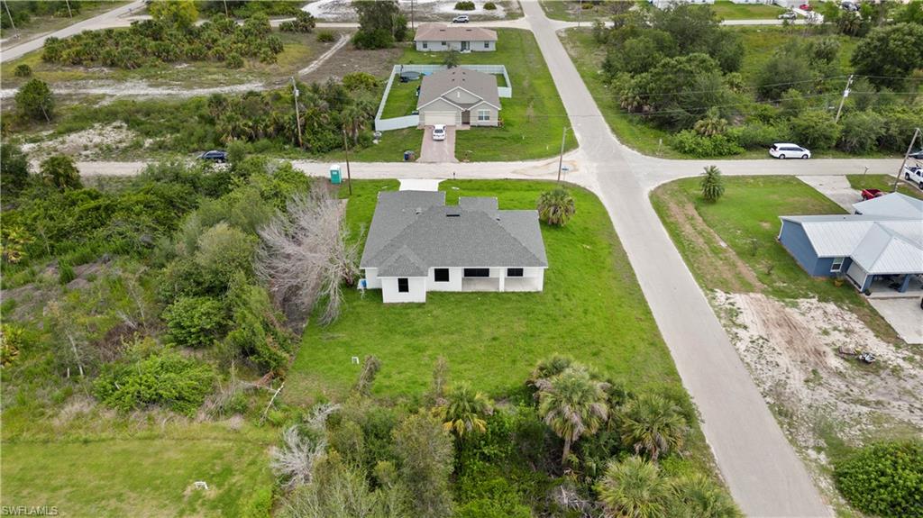 2617 3rd Street Southwest Lehigh Acres, FL 33976 - Photo 21 of 22 an aerial view of a house with outdoor space pool lawn chairs and couches