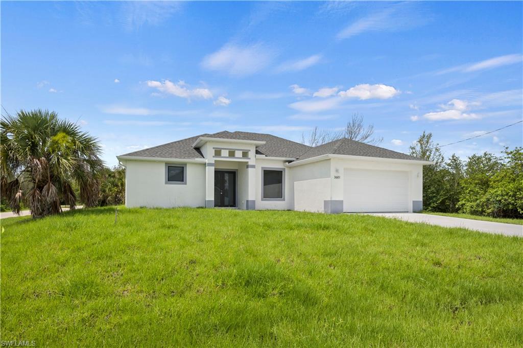 2617 3rd Street Southwest Lehigh Acres, FL 33976 - Photo 3 of 22 a view of a big house with a big yard and palm trees