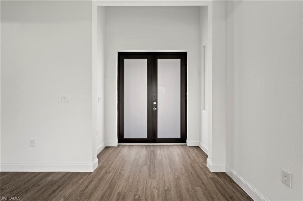 2617 3rd Street Southwest Lehigh Acres, FL 33976 - Photo 4 of 22 a view of an empty room with wooden floor