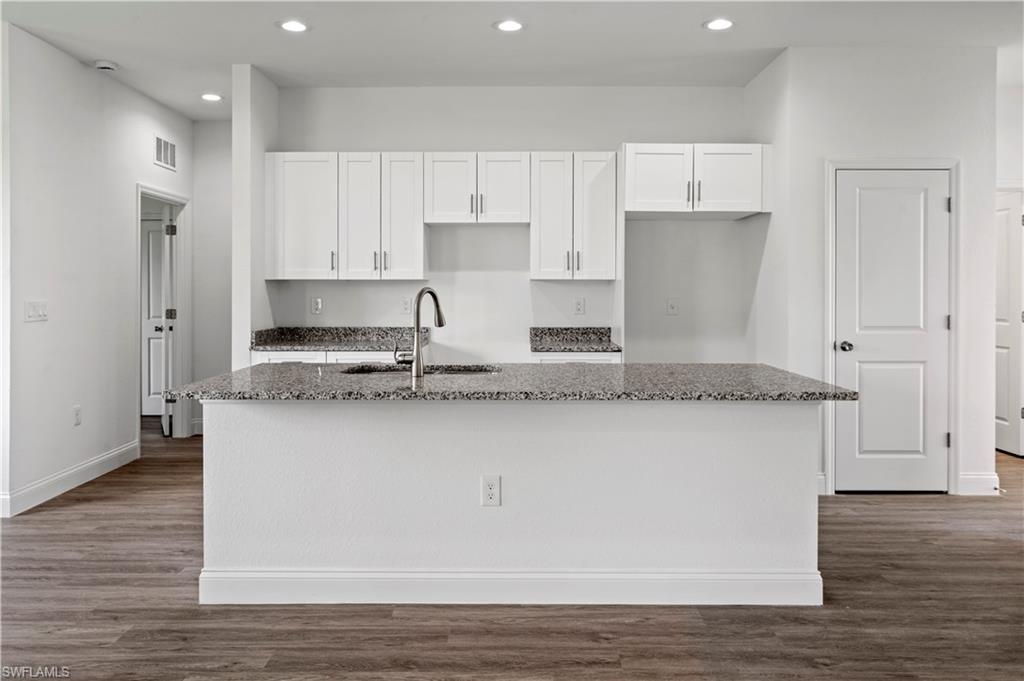 2617 3rd Street Southwest Lehigh Acres, FL 33976 - Photo 6 of 22 a kitchen with stainless steel appliances granite countertop a stove a sink and a refrigerator