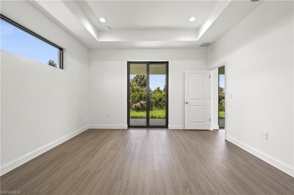 2617 3rd Street Southwest Lehigh Acres, FL 33976 - Photo 8 of 22 an empty room with wooden floor and natural light