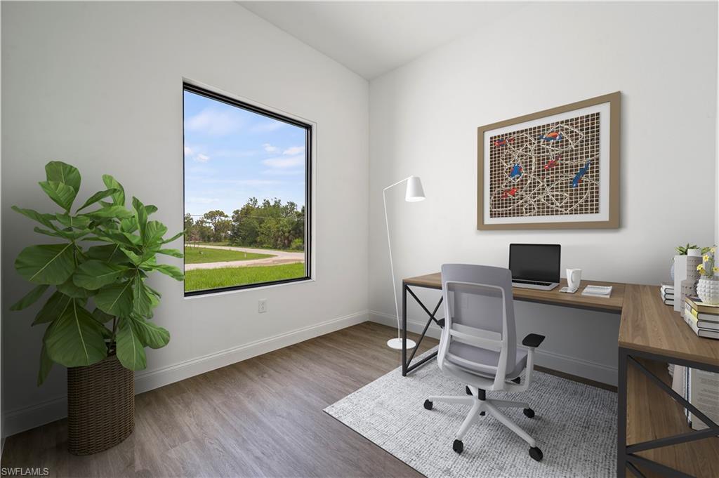 2617 3rd Street Southwest Lehigh Acres, FL 33976 - Photo 9 of 22 a workspace with furniture and a potted plant