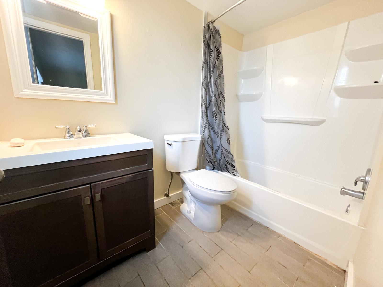 202 Lucerne Avenue, Unit 10 Lake Worth Beach, FL 33460 - Photo 11 of 16 a bathroom with a sink a toilet and shower