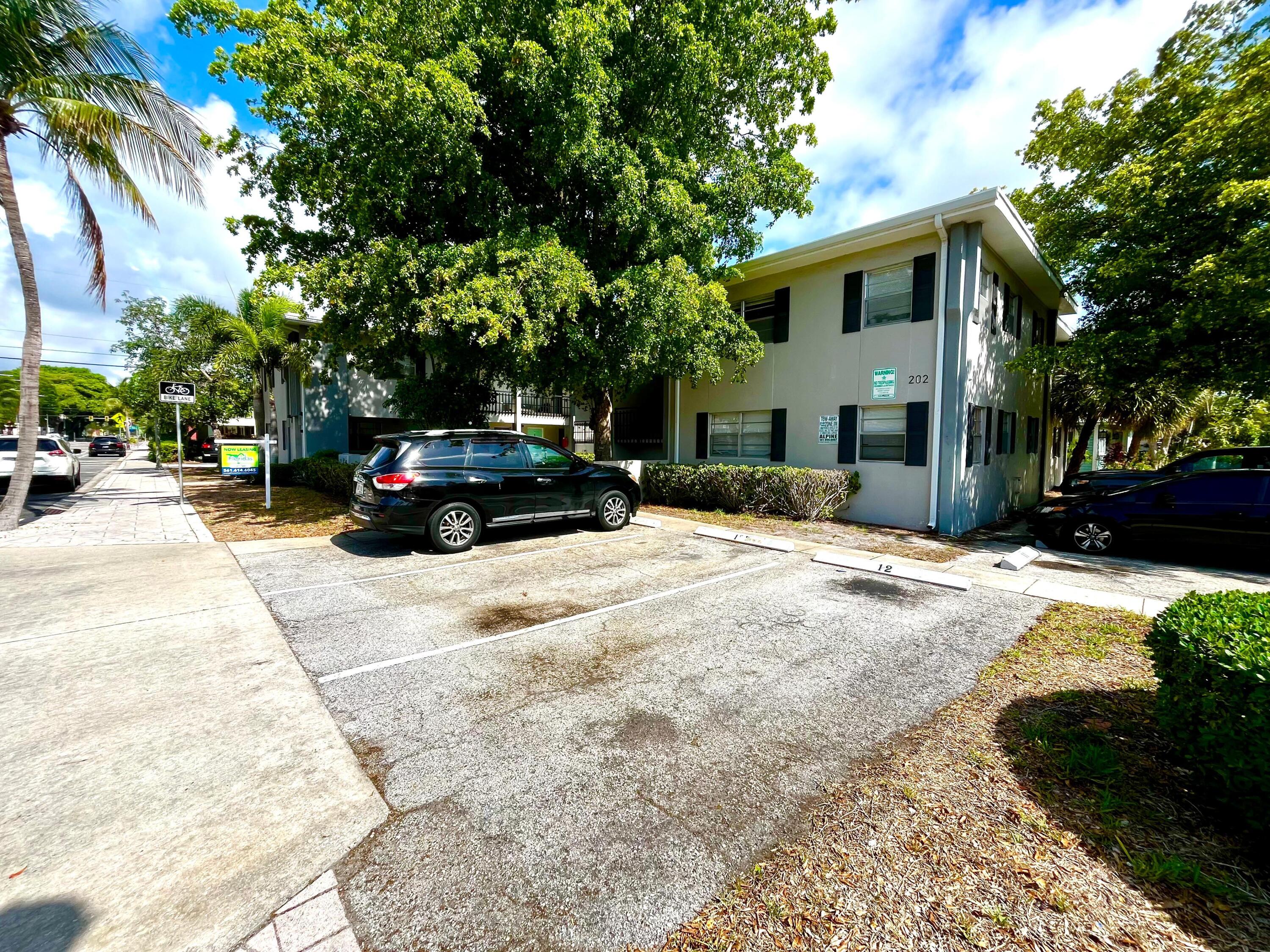 202 Lucerne Avenue, Unit 10 Lake Worth Beach, FL 33460 - Photo 16 of 16 a view of a car parked in front of a house