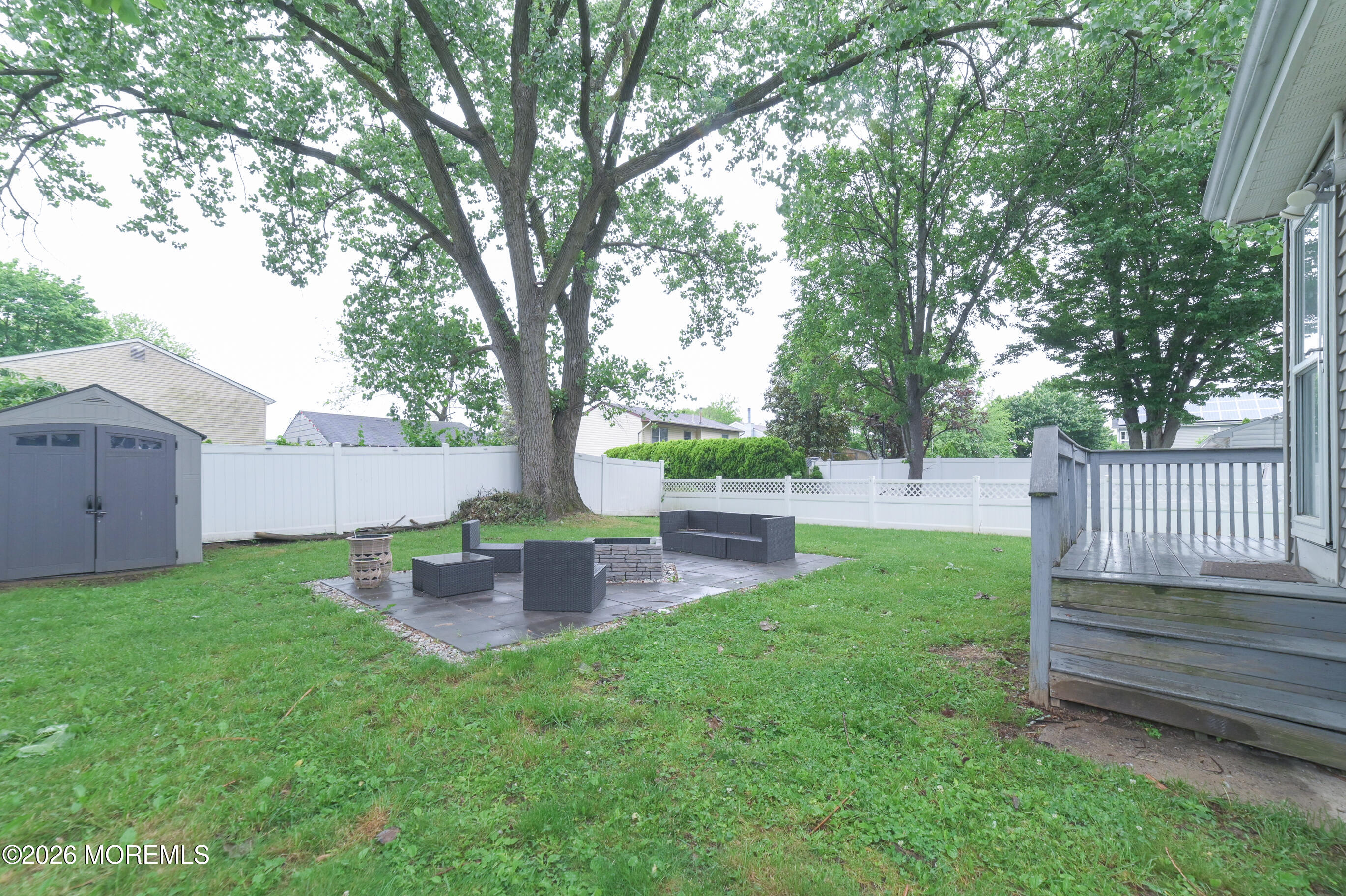 501 Gulden Street Keyport, NJ 07735 - Photo 13 of 14 a view of a backyard with wooden fence and a large tree
