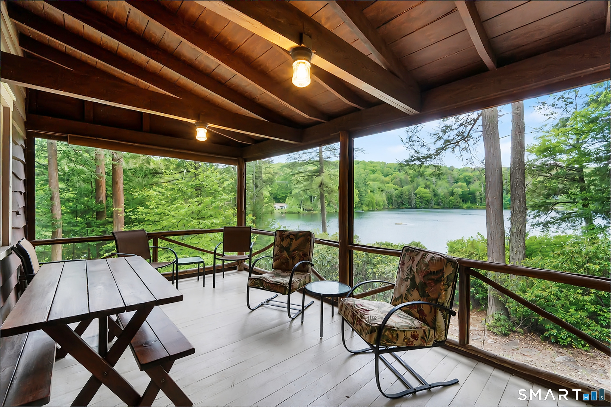 47 Pinehurst Road Hartland, CT 06091 - Photo 17 of 39 a view of a patio with chairs and floor to ceiling window