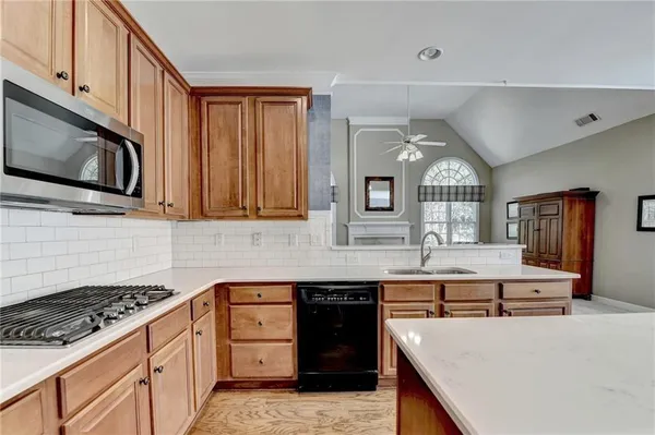 a kitchen with stainless steel appliances a stove microwave and cabinets