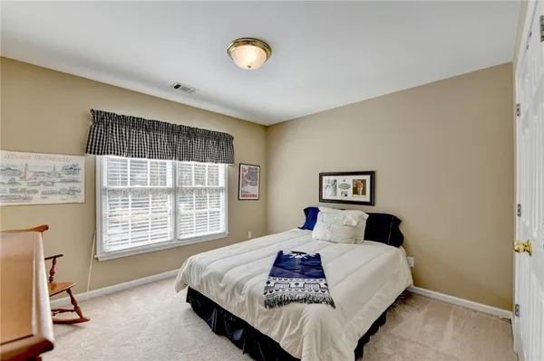 a bedroom with a large bed and a window