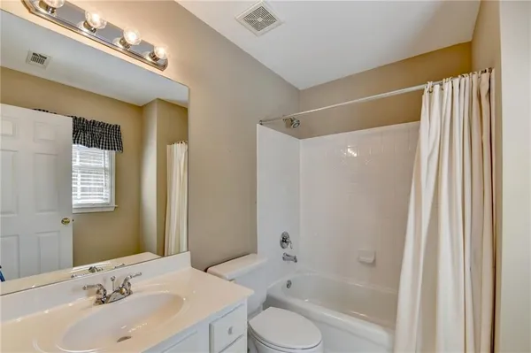 a bathroom with a sink toilet tub and shower