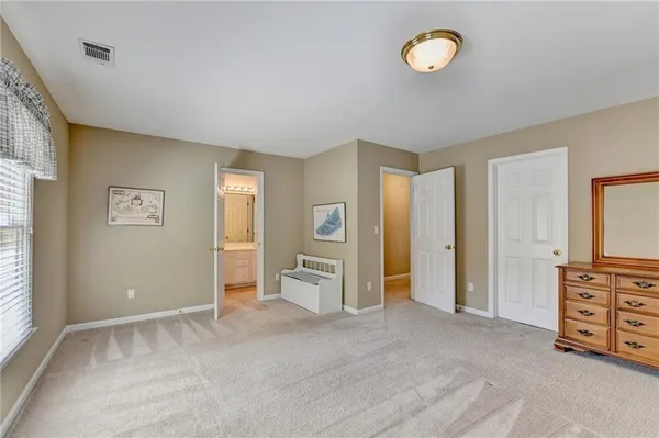 a view of a bedroom with furniture and window